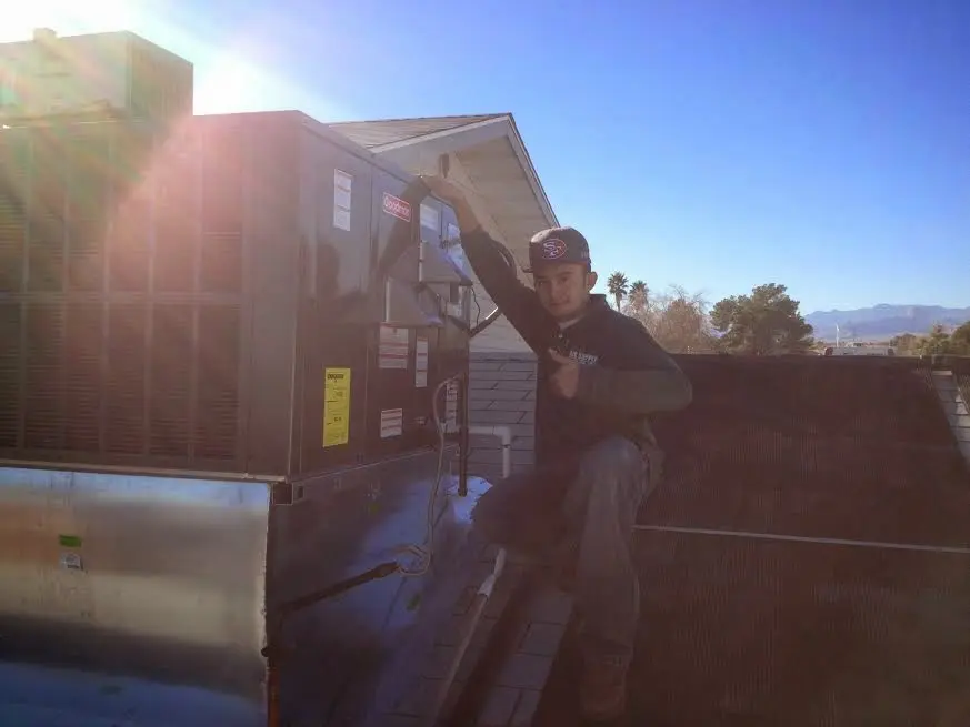 HVAC technician performing Boiler Repair on a rooftop unit in Park City